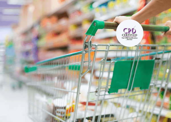 A green shopping trolley being pushed through a supermarket aisle, with stocked shelves blurred in the background to depict a retail food safety setting.