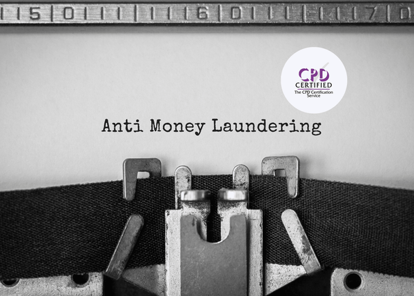 Close-up of a typewriter typing the phrase “Anti Money Laundering” in black ink on white paper.