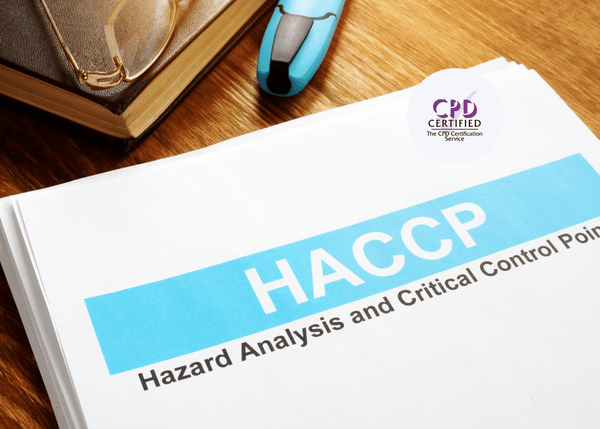 HACCP training manual placed on a wooden desk with reading glasses and a blue highlighter beside it, symbolising food safety learning.