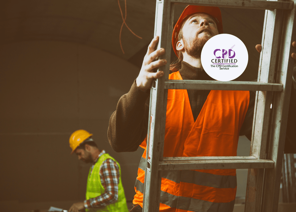 A construction worker in a high-vis vest climbs a ladder on site, illustrating essential practices taught in the CPD Ladder Safety course.