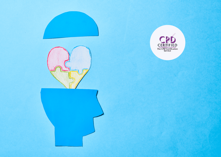 A blue paper cut-out of a human head with the top lifted reveals a multicoloured puzzle-piece heart inside, symbolising learning disabilities and neurodiversity.