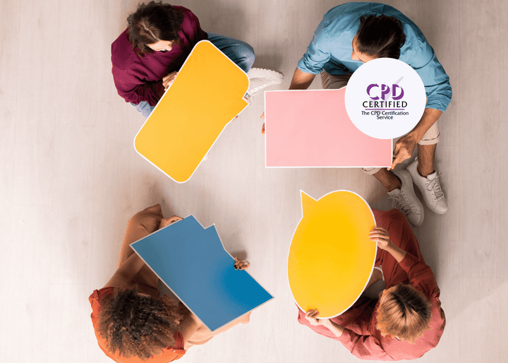 Overhead shot of five people seated in a circle, each holding a brightly coloured blank speech bubble sign, symbolising communication and idea sharing.