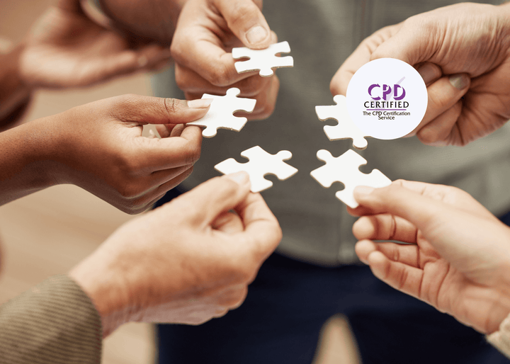 Close-up of multiple hands holding white puzzle pieces, appearing poised to connect them together.