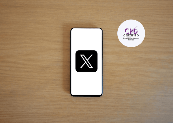 Smartphone with a black 'X' logo on a wooden surface, next to a 'CPD Certified' badge.