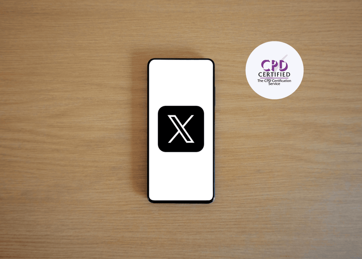 Smartphone with a black 'X' logo on a wooden surface, next to a 'CPD Certified' badge.