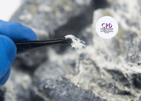 Individual wearing blue protective gloves using tweezers to handle a white, fibrous material.