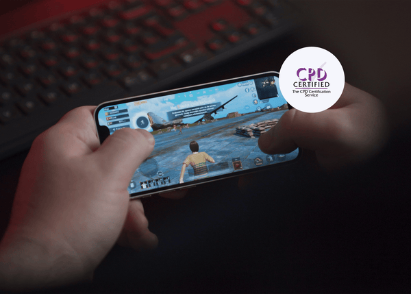 Hands holding a smartphone playing an online multiplayer game, illustrating a concept from online gaming safety training.