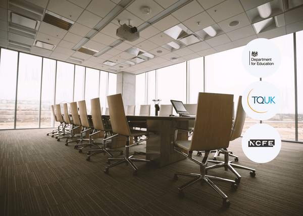 Modern conference room with large windows and a long table with chairs, featuring logos of educational organisations.