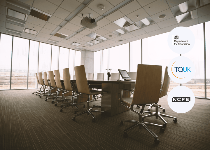 Modern conference room with large windows and a long table with chairs, featuring logos of educational organisations.