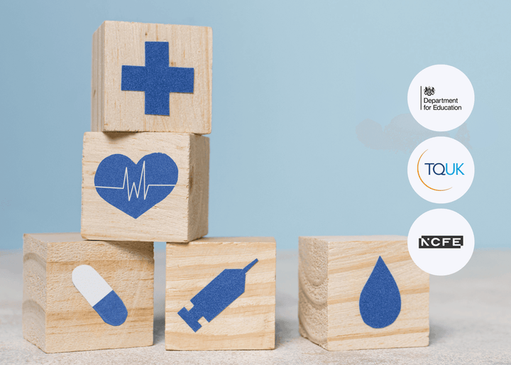 Five wooden blocks featuring blue healthcare icons, including a heart, pill, syringe, and droplet, are neatly stacked on a light surface, symbolising medical care.