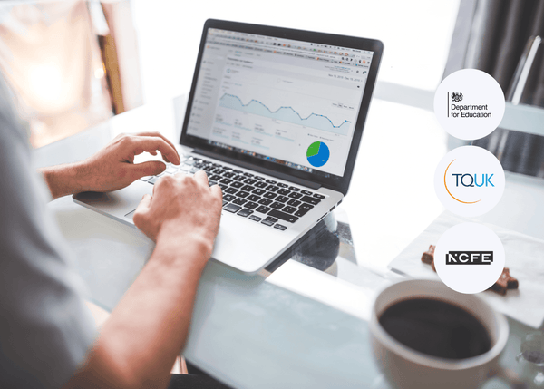 Person typing on a laptop displaying digital marketing analytics charts and graphs, with a coffee cup placed in the foreground.