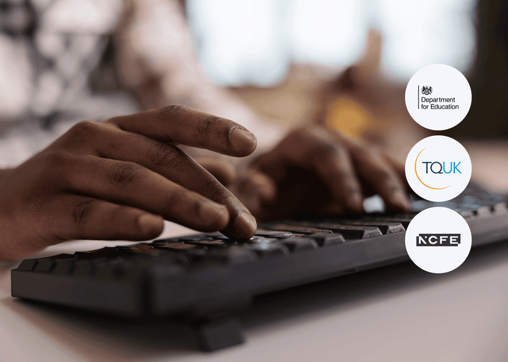 Close-up of hands typing on a black computer keyboard with a softly blurred indoor background and natural daylight.