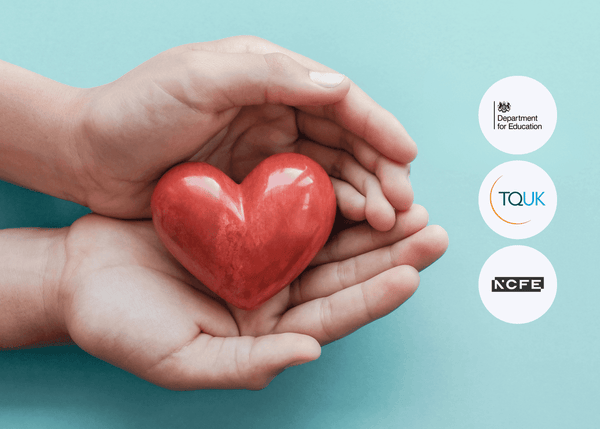 Two hands gently holding a small red heart against a teal background, symbolising compassion, care, and support in health and social care.