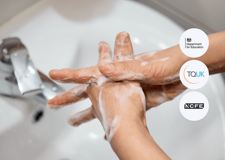 Close-up of hands being washed under running water, thoroughly scrubbed with soap and covered in lather to highlight proper hygiene practices.