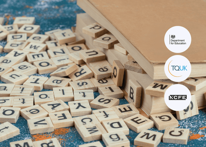 Scattered wooden letter tiles spread across a surface beside closed books, with letters facing in various directions, symbolising Specific Learning Difficulties (SpLDs).