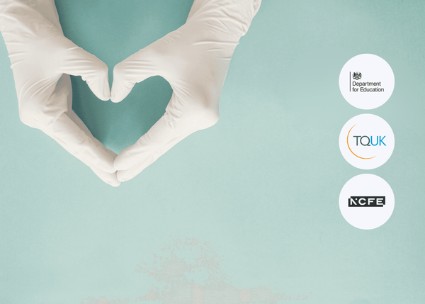 Two hands wearing medical gloves form a heart shape against a soft teal background, with thumbs and fingertips meeting to symbolise care and support.